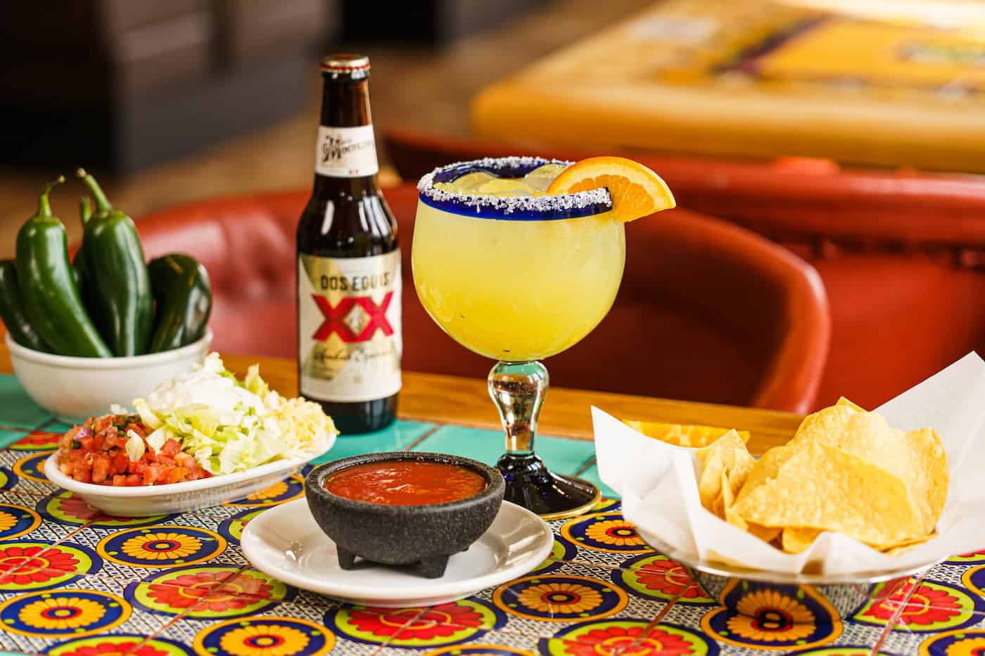 Fresh margaritas, salsa, and chips on a Talavera-tiled table at Acapulco's